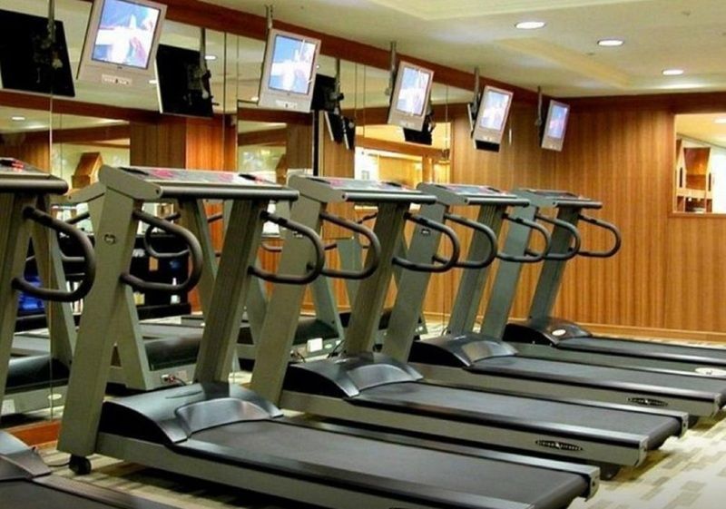 Evergreen Laurel Hotel - Taizhong Zewnętrze zdjęcie The photo shows a fitness area with several treadmills lined up in front of a wall of mirrors. Each treadmill is equipped with a console and has screens above them, likely displaying workout information or entertainment. The interior has a modern des